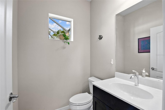 bathroom with toilet and vanity