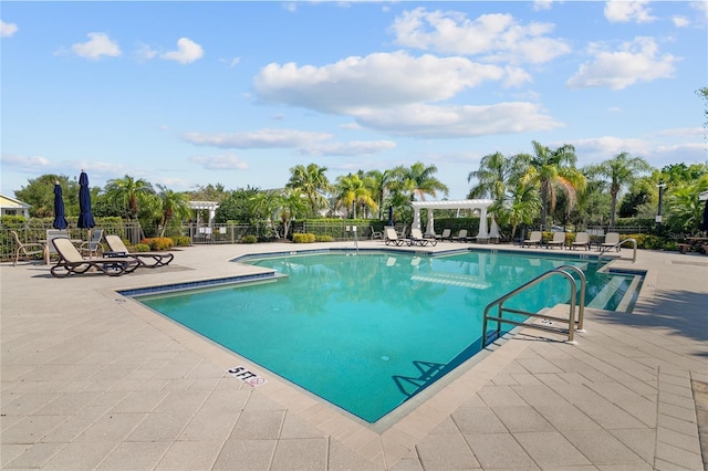 view of swimming pool with a patio and a pergola