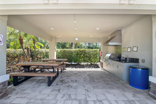 view of patio / terrace with area for grilling, sink, and a grill