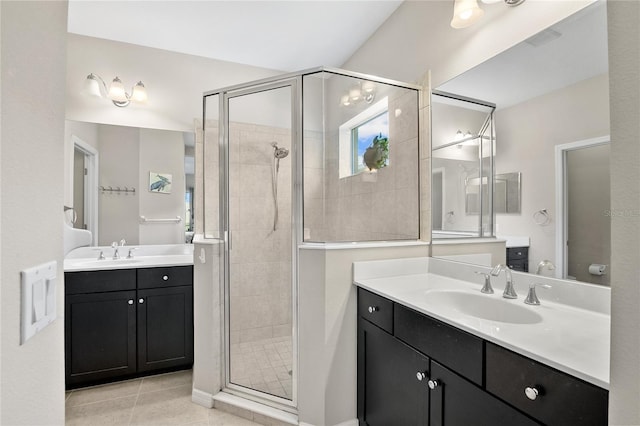 bathroom with vanity, a shower with shower door, and tile patterned floors