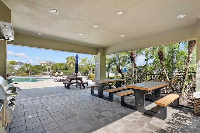 view of patio / terrace with a fenced in pool