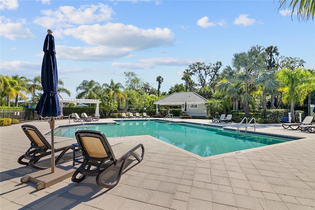 view of swimming pool featuring a pergola and a patio area