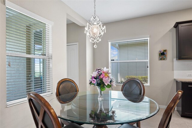 tiled dining space with a notable chandelier