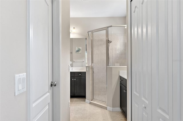 bathroom featuring vanity, tile patterned floors, and walk in shower