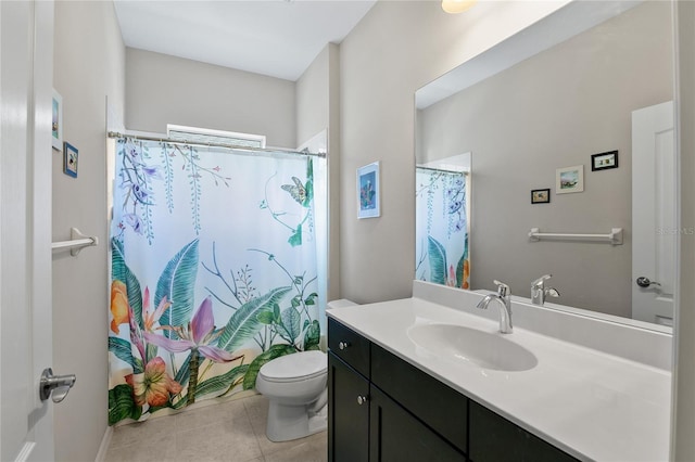 bathroom with tile patterned flooring, vanity, and toilet