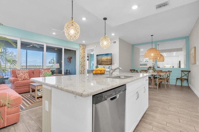 kitchen with open floor plan, stainless steel dishwasher, wood finish floors, and a sink