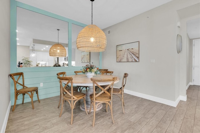 dining area with visible vents, baseboards, wood finished floors, and recessed lighting