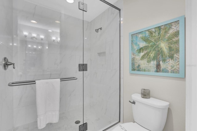 bathroom with toilet and a marble finish shower