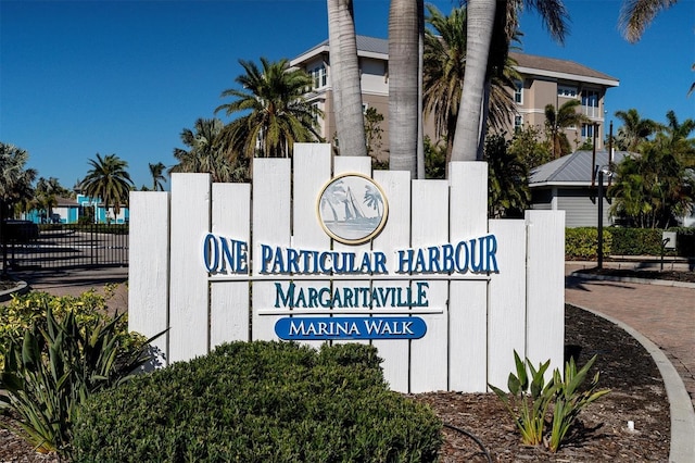 community sign featuring fence