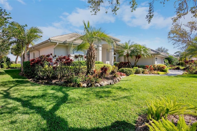 view of property exterior featuring a yard, an attached garage, and stucco siding