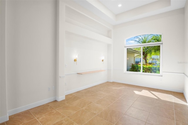 unfurnished room with recessed lighting, light tile patterned flooring, and baseboards