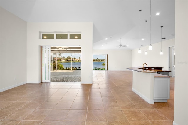 interior space featuring a sink, recessed lighting, a ceiling fan, and light tile patterned flooring