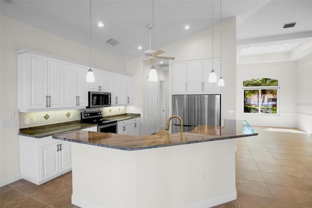 kitchen featuring visible vents, appliances with stainless steel finishes, a large island with sink, and light tile patterned flooring