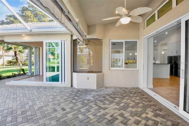 view of patio / terrace featuring ceiling fan and a lanai