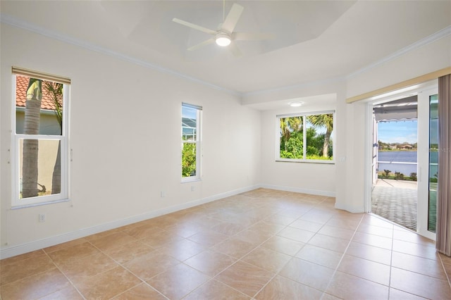 empty room featuring light tile patterned floors, baseboards, ornamental molding, and a ceiling fan