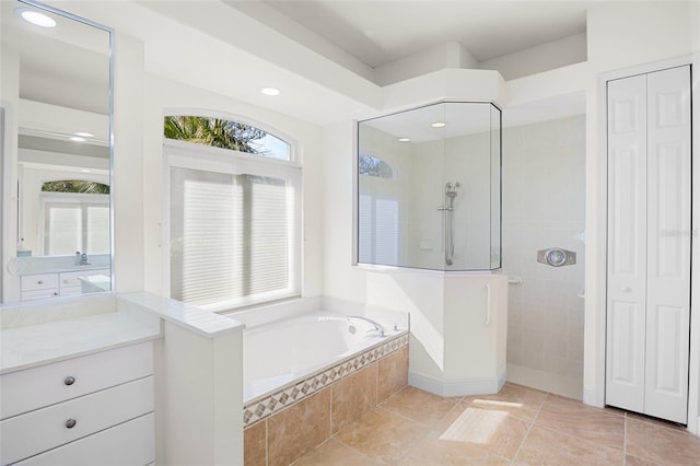 full bathroom with a garden tub, a closet, vanity, tile patterned flooring, and walk in shower