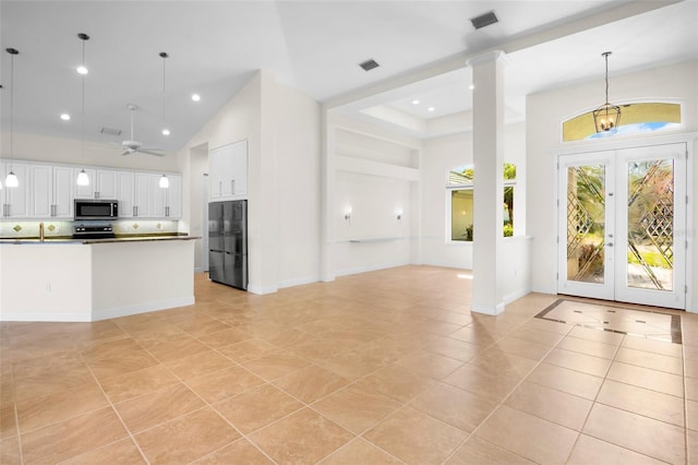 4941 Sabal Lake Cir, Sarasota, FL 34238 - foyer featuring light tile patterned floors, french doors, a ceiling fan, a high ceiling, and recessed lighting