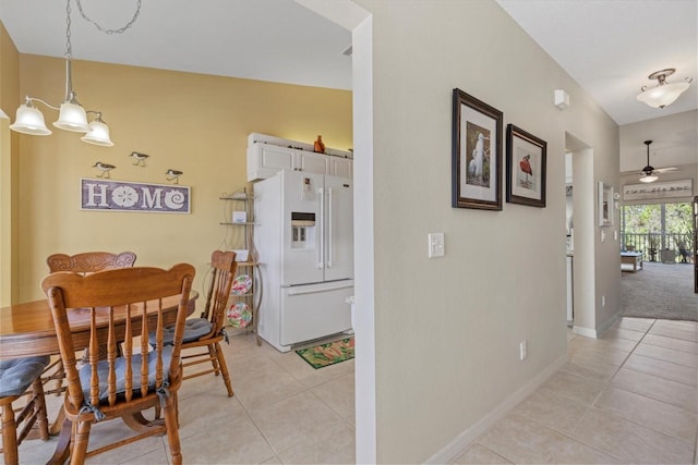 dining space featuring ceiling fan and light tile patterned floors