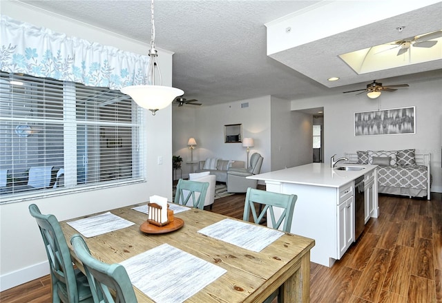 dining room with a textured ceiling, ceiling fan, dark wood-type flooring, and baseboards