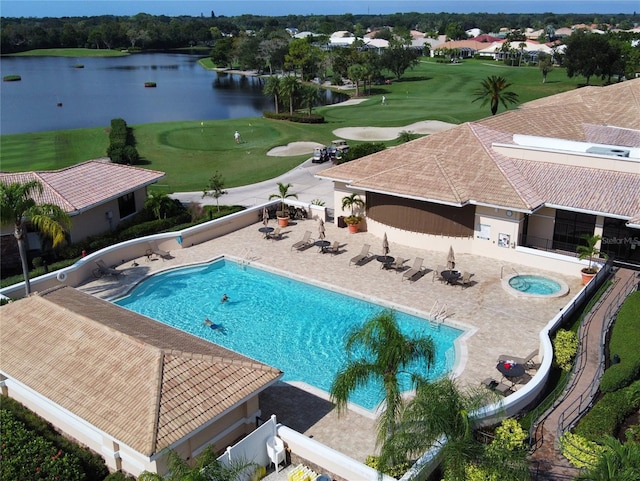 pool featuring view of golf course, a water view, and a patio