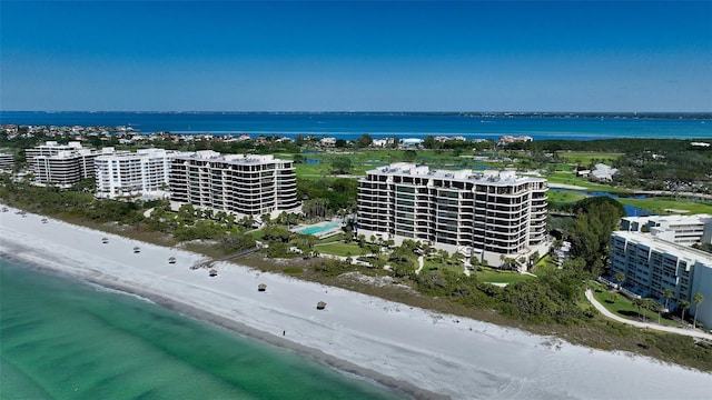 bird's eye view with a water view, a view of the beach, and a city view