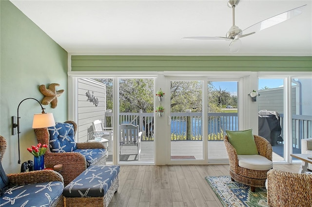 sunroom featuring ceiling fan