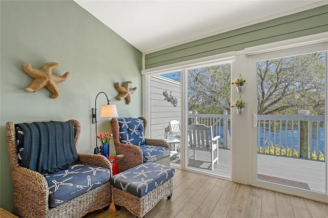 sunroom featuring a healthy amount of sunlight and lofted ceiling