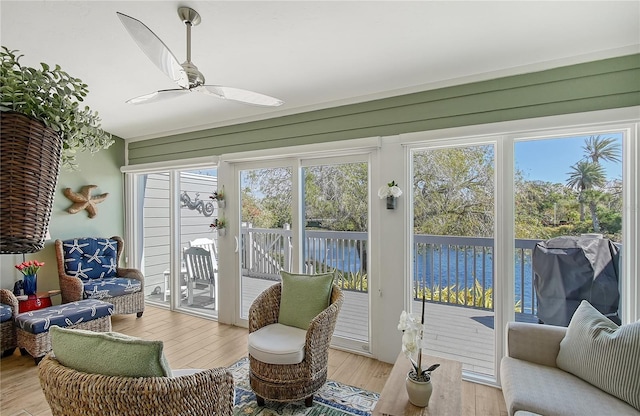 sunroom / solarium featuring ceiling fan