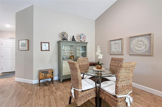 dining room featuring light wood-type flooring and baseboards