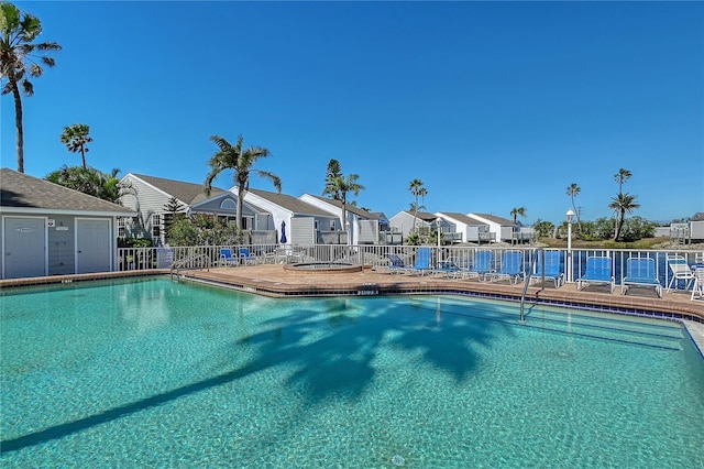 view of pool with a residential view and fence