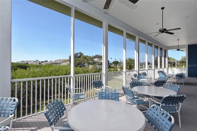 sunroom featuring a ceiling fan