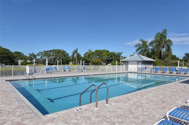 community pool featuring a patio and fence