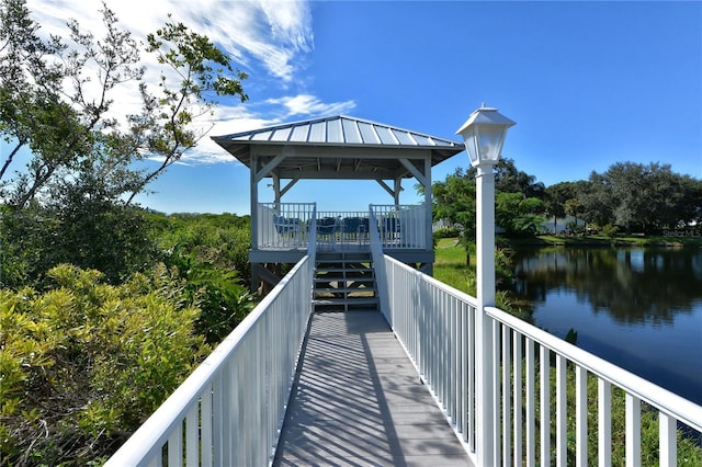 view of community with a gazebo and a water view