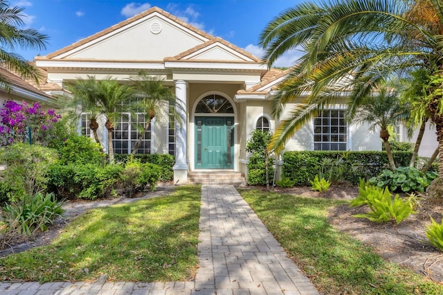 view of front of home featuring stucco siding and a tiled roof