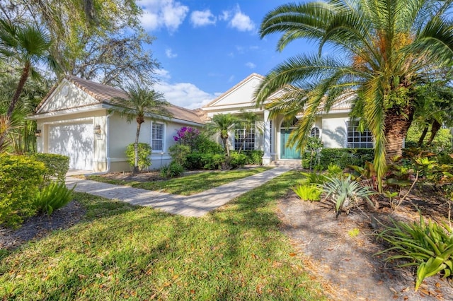 ranch-style home featuring stucco siding, an attached garage, and a front lawn