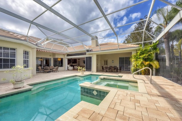 view of swimming pool featuring a patio area, outdoor dining space, and a pool with connected hot tub