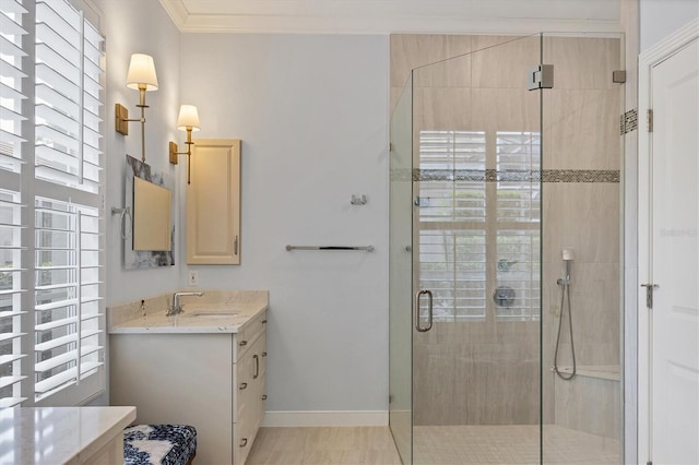 full bathroom with baseboards, vanity, ornamental molding, and a shower stall