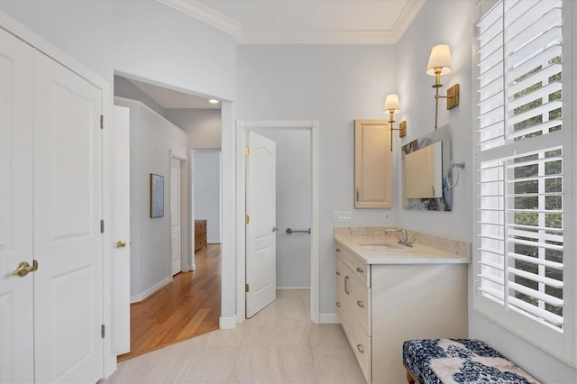 bathroom with tile patterned flooring, crown molding, and plenty of natural light