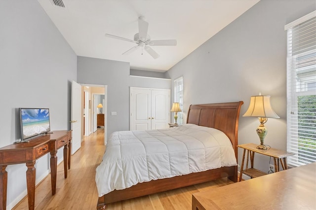 bedroom featuring ceiling fan, a closet, visible vents, and light wood-style flooring