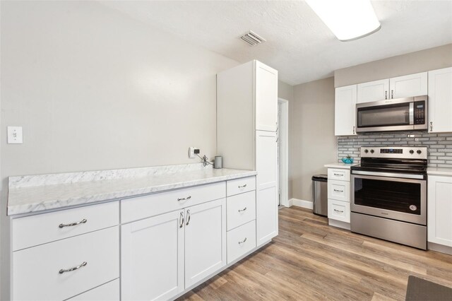 kitchen featuring white cabinetry and appliances with stainless steel finishes