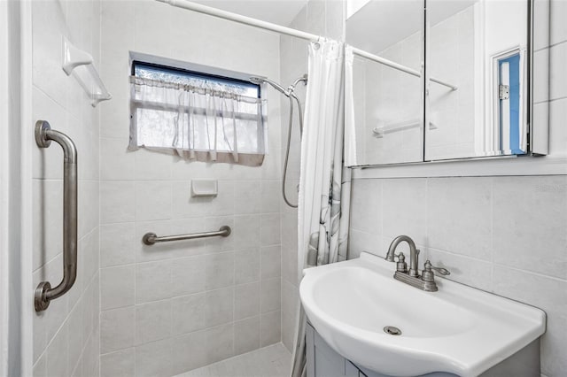 bathroom featuring sink, tile walls, and a shower with curtain