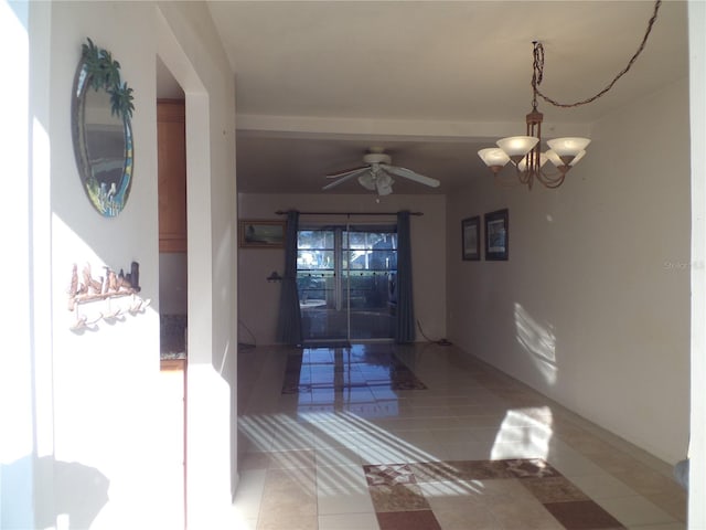 corridor with a notable chandelier and light tile patterned floors
