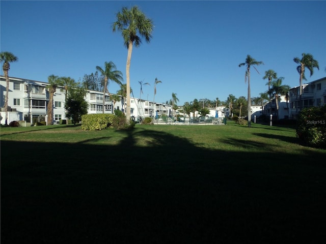 surrounding community with a yard