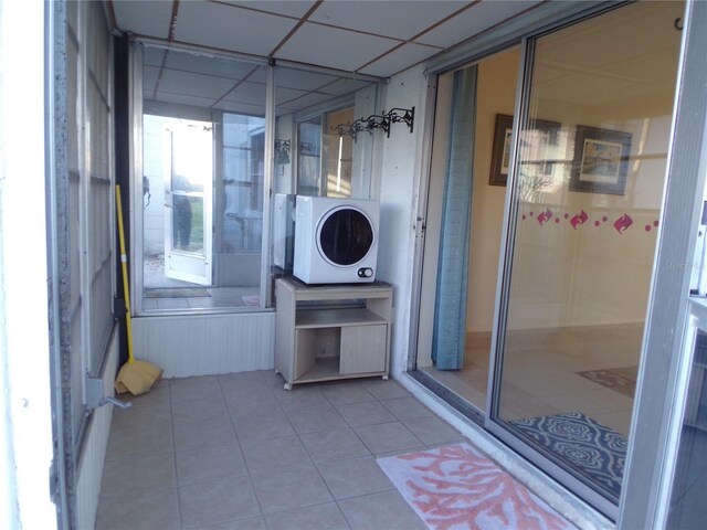 bathroom featuring a drop ceiling and tile patterned flooring