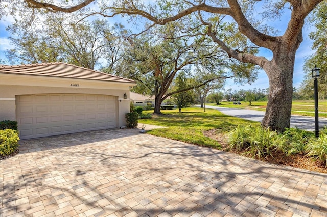 garage featuring decorative driveway