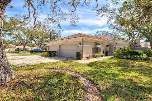 view of front of property featuring a garage, a front yard, decorative driveway, and stucco siding