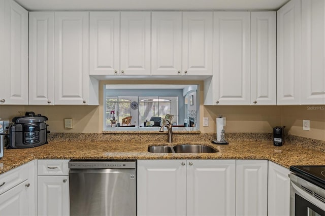 kitchen with appliances with stainless steel finishes and white cabinets