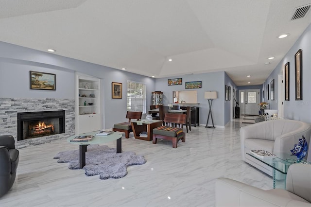 living room with built in shelves, a fireplace, visible vents, marble finish floor, and a tray ceiling