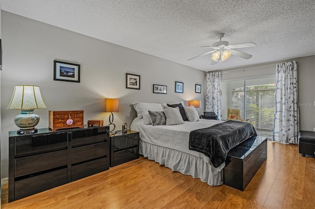 bedroom featuring ceiling fan, a textured ceiling, and wood finished floors