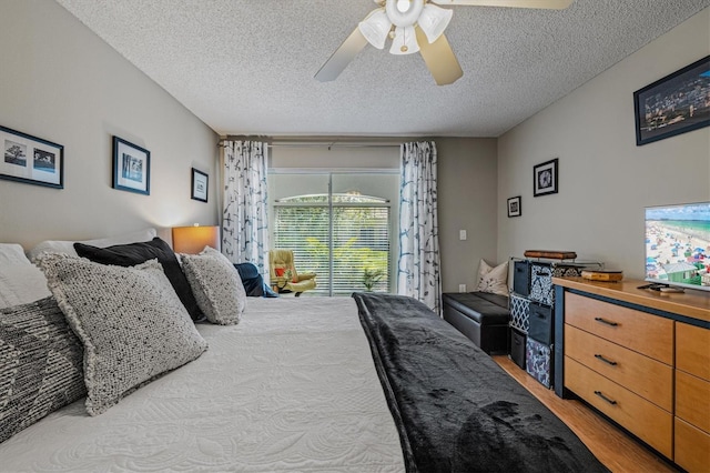 bedroom with a textured ceiling, access to outside, light wood-type flooring, and a ceiling fan